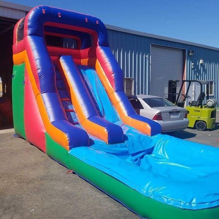 Tall water slide with a full splash pool at the bottom, inflated and ready